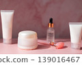Skincare beauty products set with facial roller, cream jar, serum dropper and cosmetic bottles on pink background, beauty routine concept 139016467