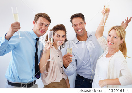 Business people, champagne and portrait for celebration, success and teamwork or achievement at staff party. Group of employees or friends with wine glasses and office drinks by white wall background Business people, champagne and portrait for celebration, success and teamwork or achievement at staff party. Group of employees or friends with wine glasses and office drinks by white wall background 139016544