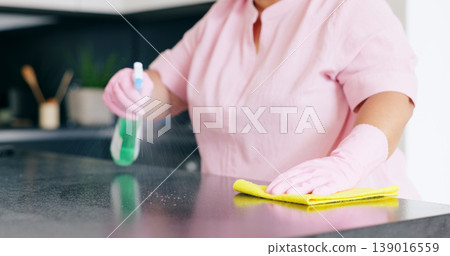 Cleaning, woman or spray on kitchen counter with detergent, housekeeper or service for home hygiene. Hands, person and cloth in housekeeping to shine, sanitizer and disinfectant for surface in house 139016559