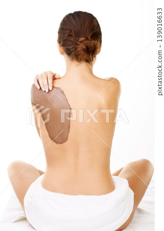 Mud, treatment and back of woman with skincare, detox or natural cosmetics in white background or studio. Dermatology, care and person with application of dirt, mask or exfoliate skin and body in spa Mud, treatment and back of woman with skincare, detox or natural cosmetics in white background or studio. Dermatology, care and person with application of dirt, mask or exfoliate skin and body in spa 139016633