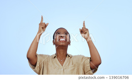 Woman, point and studio smile for information announcement, feedback for promotion. Black person, model or hand gesture mockup space or blue background for opinion deal, excited or good news review 139016706