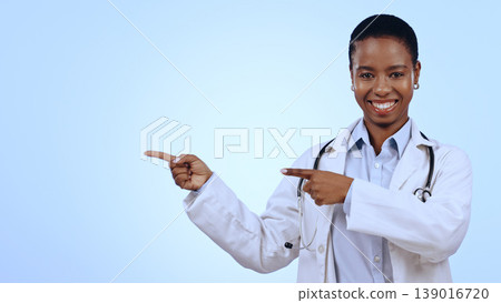 Woman, portrait and pointing for announcement in studio with smile, presentation or advertising space. Doctor, black person and happy for marketing, showing deal or discount with hand and joy mockup Woman, portrait and pointing for announcement in studio with smile, presentation or advertising space. Doctor, black person and happy for marketing, showing deal or discount with hand and joy mockup 139016720