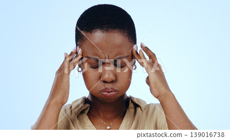 Woman, headache and stress in studio for pain dizzy, anxiety fatigue on blue background. Black person, brain fog as migraine fear for tired crisis or frustrated vertigo problem, burnout as mockup Woman, headache and stress in studio for pain dizzy, anxiety fatigue on blue background. Black person, brain fog as migraine fear for tired crisis or frustrated vertigo problem, burnout as mockup 139016738