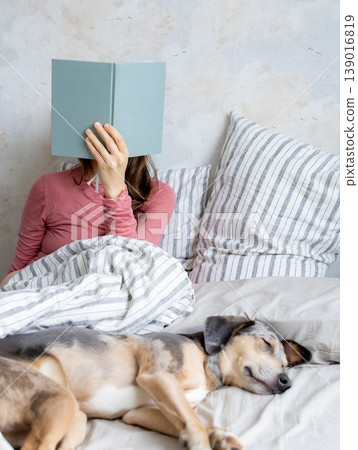 woman in bed writes in personal diary, writes down emotions, writes down wish list. mental health. 139016819