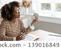 female architect or realtor holds mock up of house in her hands, deals with planning. 139016849