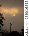 sun in mist among trees. foggy morning in city. sunny weather at dawn.  139016855