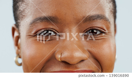 Happy, eyes and portrait of black woman on blue background for confidence, pride and beauty. Cosmetics, closeup and face of African person smile with happiness, makeup and dermatology in studio 139016890