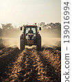 Plowing Field with Tractor 139016994