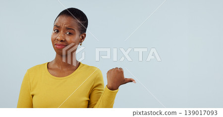 Disappointed, pointing and portrait of black woman in studio with why, question and doubt. Emoji, what and face of person with hand gesture for announcement, information and news on blue background Disappointed, pointing and portrait of black woman in studio with why, question and doubt. Emoji, what and face of person with hand gesture for announcement, information and news on blue background 139017093