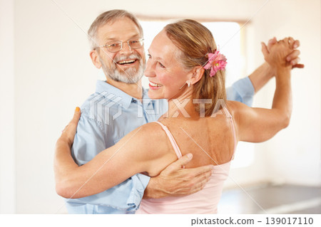Senior couple, dancing and happiness in home, love and ballroom for fun, touch and romantic. Retirement, bonding together and smile for husband, wife and quality time with tango, retired or elderly 139017110