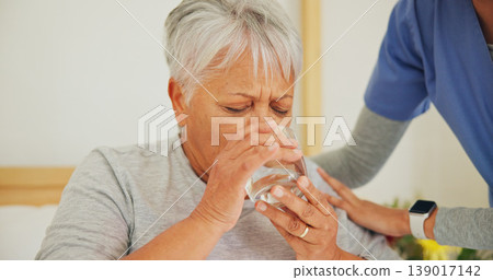 Nurse, senior woman and drinking water for medication in healthcare, support or trust at old age home. Closeup of mature patient with mineral drink, beverage or medical caregiver in natural nutrition 139017142