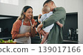 Family, smile and pacifier in kitchen, love and bonding or fun, relax and support or laughing on diet. Happy parents and baby, connect and humor or cooking, nutrition and healthy food or meal at home 139017166