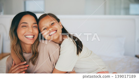 Portrait, family and a mother hugging her daughter in the bedroom of a home in the morning together. Face, smile and a happy young girl embracing her single parent while on a bed in their apartment Portrait, family and a mother hugging her daughter in the bedroom of a home in the morning together. Face, smile and a happy young girl embracing her single parent while on a bed in their apartment 139017189