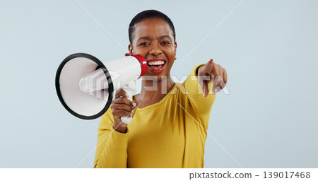 Happy black woman, portrait and pointing to you with megaphone for choice against a gray studio background. African female person smile with loudspeaker or bullhorn for selection, choosing or sale Happy black woman, portrait and pointing to you with megaphone for choice against a gray studio background. African female person smile with loudspeaker or bullhorn for selection, choosing or sale 139017468