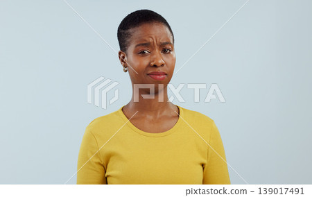 Black woman, portrait and confused face in question, dont know or unsure against a gray studio background. Clueless African female person or model in doubt, decision or choice with facial expression 139017491