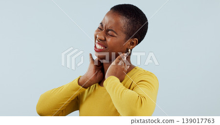 Black woman, neck pain and injury in stress, pressure or anxiety against a gray studio background. Face of frustrated African female person or model with sore joint, inflammation or ache on mockup 139017763