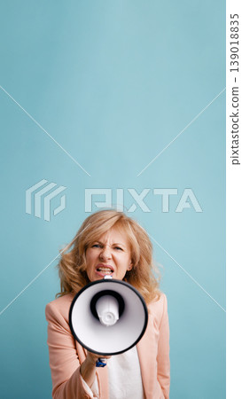Woman shouting through megaphone expressing protest or demand Woman shouting through megaphone expressing protest or demand 139018835
