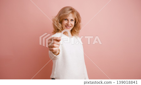 Woman showing clear dental aligner for teeth straightening 139018841