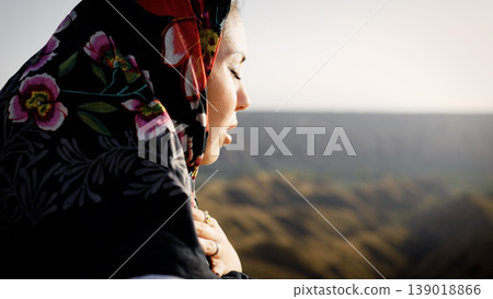 Muslim woman praying outdoors finding spiritual connection 139018866