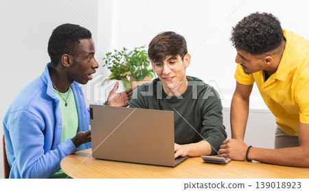 Startup founders discussing business strategy on laptop: teamwork and collaboration in modern office 139018923