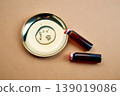 Cosmetic serum oil droplets on gold plate with vials 139019086