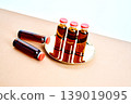 Pharmaceutical vials containing amber liquid medicine on gold tray 139019095