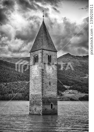 The iconic submerged Church Tower of Graun, Lake Reschensee, Italy The iconic submerged Church Tower of Graun, Lake Reschensee, Italy 139020011