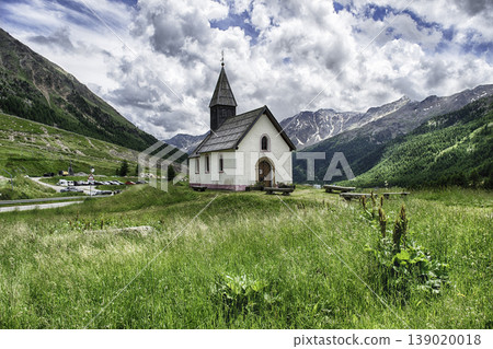 Small church standing on a green meadow, Italian Alps Small church standing on a green meadow, Italian Alps 139020018
