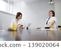 Businesswoman in white shirt reviewing documents with coffee and yellow cup in daylight office. Reviewing, documents, coffee, office, businesswoman. 139020064