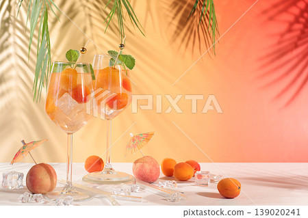 Modern still life with fruits. Royal lemonade cocktail with peach, apricot, mojito with tequila, gin, rum, ice and fresh mint, bar and party concept, restaurant and cafe advertising card 139020241