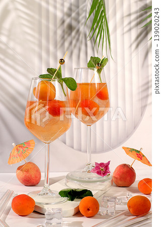 Royal lemonade cocktail with peach, apricot, mojito with tequila, gin, rum, vodka, liqueur, lime, ice and fresh mint, bar and party concept, restaurant and cafe advertising card, summer alcoholic Royal lemonade cocktail with peach, apricot, mojito with tequila, gin, rum, vodka, liqueur, lime, ice and fresh mint, bar and party concept, restaurant and cafe advertising card, summer alcoholic 139020243
