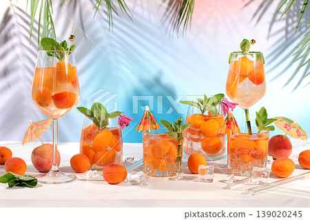 Modern still life with mojito, alcoholic cocktail, peach, apricot and mint berries on elegant modern background, minimalist concept for bar and holiday party, cafe, advertising banner, 139020245