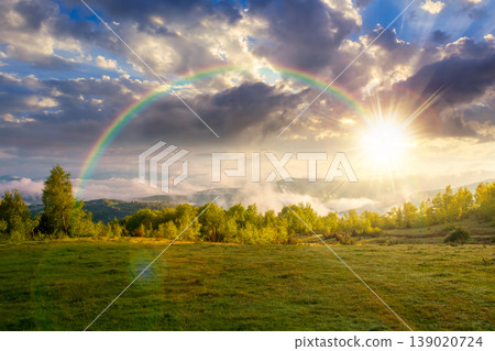 foggy sunset over carpathian mountain landscape. outdoor adventure with stunning view in evening light. countryside landscape with rolling hills, fog and cloudy sky. weather with rainbow foggy sunset over carpathian mountain landscape. outdoor adventure with stunning view in evening light. countryside landscape with rolling hills, fog and cloudy sky. weather with rainbow 139020724