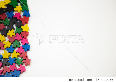 Small multi-colored wooden men lie on the side on a white background with space for text. The concept of people, society, meetings, meetings. High quality photo Small multi-colored wooden men lie on the side on a white background with space for text. The concept of people, society, meetings, meetings. High quality photo 139020936