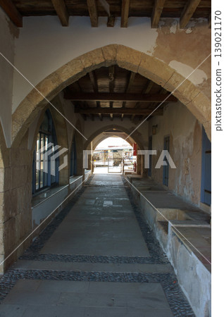 Exploring the charming stone arches of an ancient marketplace in Cyprus at midday. Exploring the charming stone arches of an ancient marketplace in Cyprus at midday. 139021170