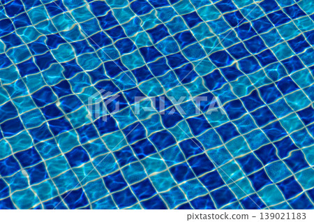 Rippling water patterns create a mesmerizing blue mosaic in a sunlit swimming pool 139021183