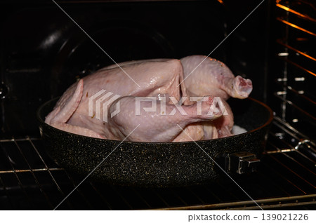 Roasting a whole turkey in a dark oven during a cozy autumn evening 139021226