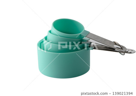 Green plastic measuring cup set for dry and liquid ingredients on white background Green plastic measuring cup set for dry and liquid ingredients on white background 139021394