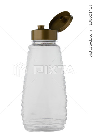 Clear glass bottle or dispenser for honey, syrup, or beverages, isolated on white. Clear glass bottle or dispenser for honey, syrup, or beverages, isolated on white. 139021419