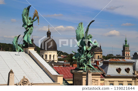 Symbolic patina sculptures over the roofs of the old town of Lviv in Ukraine Symbolic patina sculptures over the roofs of the old town of Lviv in Ukraine 139021644