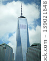 Majestic Manhattan Highrise With Reflective Glass Surface Reaching Into Clear Sky 139021648