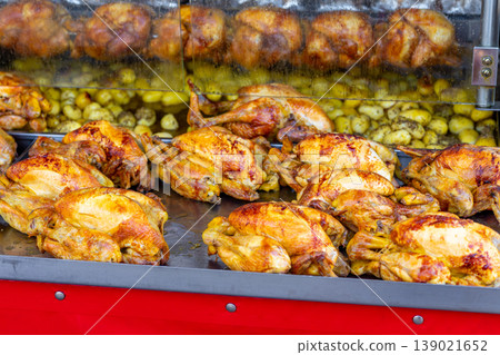 A market stall features an industrial grill oven that cooks whole chickens 139021652