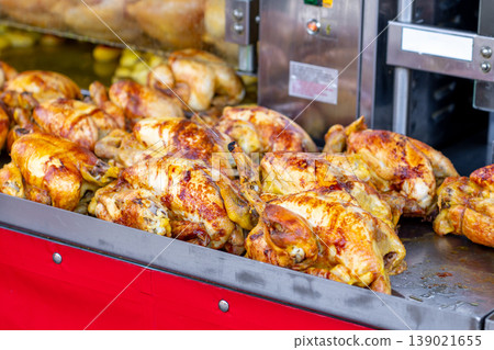 A market stall features an industrial grill oven that cooks whole chickens A market stall features an industrial grill oven that cooks whole chickens 139021655