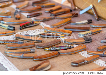 Small handmade pochet knives displayed for sale at the market 139021667