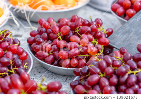 Red grapes on aluminum plates for sale at a market stall Red grapes on aluminum plates for sale at a market stall 139021673
