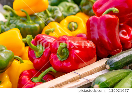 Red and yellow bell peppers for sale at a market stall Red and yellow bell peppers for sale at a market stall 139021677