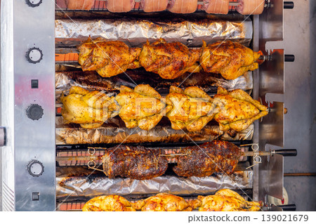 A market stall features an industrial grill oven that cooks whole chickens A market stall features an industrial grill oven that cooks whole chickens 139021679