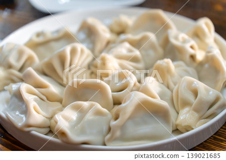 A plate of Georgian khinkali dumplings, Georgian dumplings served on a white plate A plate of Georgian khinkali dumplings, Georgian dumplings served on a white plate 139021685
