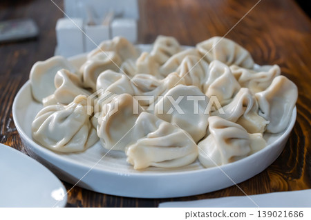 A plate of Georgian khinkali dumplings, Georgian dumplings served on a white plate A plate of Georgian khinkali dumplings, Georgian dumplings served on a white plate 139021686