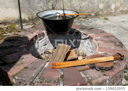 built-in fireplace in garden with cauldron and cooking utensils built-in fireplace in garden with cauldron and cooking utensils 139022035